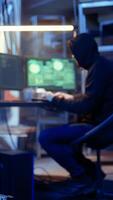 Vertical Revealing shot of spy using VPN and darknet as anonymity tools to mask online identity while stealing governmental secrets. Man in underground bunker masks his location, committing espionage, camera A video