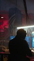Vertical Hacker in hidden location with graffiti walls using PC to deploy malware on unsecured devices, stealing sensitive data from unaware users online and selling it on black market, jib down shot video