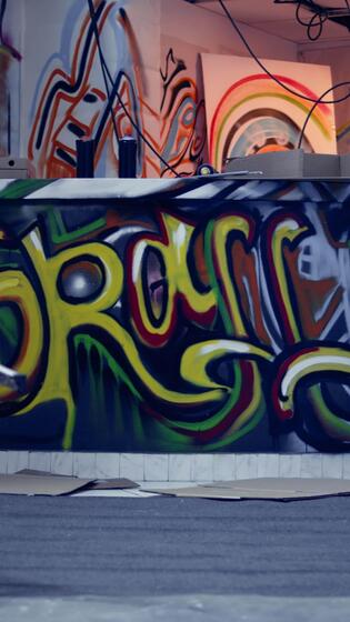 Vertical Empty destroyed infrastructure with graffiti street art 