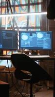 Vertical Hacker arrives in messy base of operations with neon lights and graffiti drawings sprayed on walls. Cybercriminal using ghetto hideout as HQ to commit illegal activities using computer, camera A video