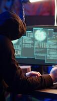 Vertical Hacker in abandoned warehouse talking on phone with partner, stealing data after using phishing technique. Man in telephone call with colleague, tricking users into revealing information, camera B video