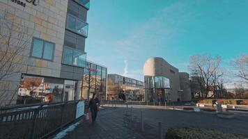 METZINGEN, GERMANY - DECEMBER 2018 People visit fashion shops in Metzingen shopping Outlet Center Complex video