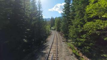 FPV drone is flying fast forward over railway track. Canada video