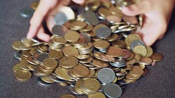 Child plays with coins. Large pile of money coins video