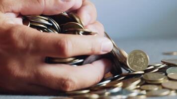 Man is holding coins in his hands. Man's hands hold a lot of gold coins. Financial, business concept. video