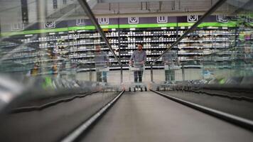 A man pushing trolley on escalator in hardware store video