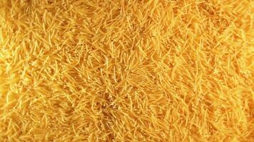 Background of Uncooked Golden Noodles that Rotating Counterclockwise - Top View. Texture of Dry Vermicelli Turning Around. Raw Pasta - Left Rotation video