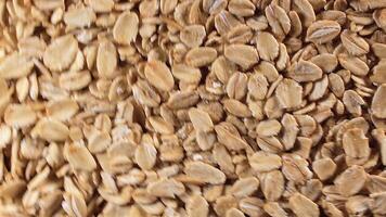 Oat Flakes Background Rotating Clockwise - Top View. Scattered Dry Oat Flakes. Healthy Breakfast and Diet Eating Ingredients - Angular Rotation Right video