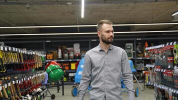 A man walking with shopping cart in a hardware store video