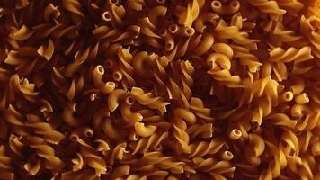 Uncooked Fusilli and Chifferi Rigati Pasta - Top View, Low Key Light. Fat and Unhealthy Food. Classic Dry Macaroni, Rotating Background. Raw Different Macaroni Pasta Texture - Rotate Left video
