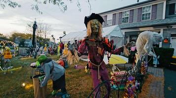 Chicago Illinois 17.10.2024 Halloween yard display with scarecrow and goblins, goblins, and spooky decorations, creating a haunting and festive scene in front of a house. video