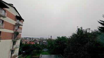 Overcast suburban view with apartment building and trees, A cloudy day overlooking a suburban neighborhood, featuring an apartment building video