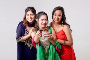 Attractive Female Models Showing Chocolate Bar in Front of Camera photo
