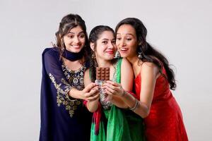 Asian Female Models With Temptation Expression Looking Towards the Chocolate Bar photo