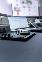 High end Home Office equipment with ergonomic keyboard and mouse and multiple monitors setup for professional work from home with company notebook and special keyboard extension gadget photo
