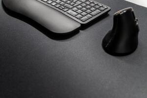 Ergonomic keyboard and ergonomic mouse as ergonomic home office equipment for freelance work and healthy workplace for notebook and clean desktop for efficient work from home for editing graphics photo