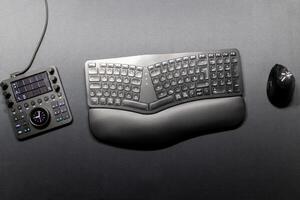 Ergonomic keyboard with ergonomic mouse for ergonomic home office equipment for freelance work and healthy workplace for notebook and clean desktop for efficient work from home for editing graphic photo