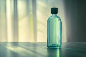 Transparent bottle filled with liquid standing on table and casting shadow photo