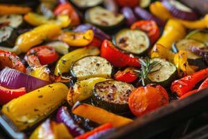 Colorful roasted vegetables seasoned with herbs and spices on a baking sheet photo
