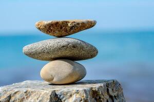 Stack of rounded zen stones balancing on top of each other photo