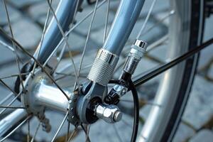 Silver bicycle dynamo is attached to the front fork of a bicycle photo