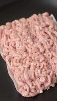 Raw minced chicken with salt, spices and herbs on a dark concrete background video