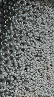 Cleaning of polymer granules. Creative. Mesh for cleaning white polymer granules from debris and foreign particles. Chemical workshop for plastic processing and cleaning video