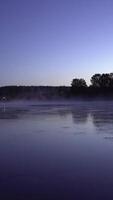 Experience the Serene Beauty of Twilight over the Riverbank, with a Misty Water Reflection. Stock Clip video
