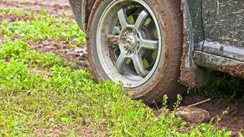 car tire slipping while stuck in a dirt, closeup video