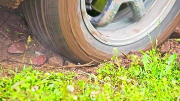 car tire slipping while stuck in a dirt, closeup video