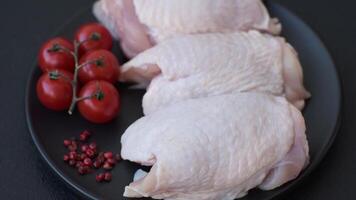 Raw chicken thighs with salt, spices and herbs prepared for grilling video