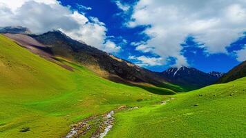 gorgeous mountain gorge with green slopes at sunny summer day in Kyrgyzstan video