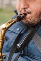 A saxophonist performs in a serene park during autumn while seated on a bench photo