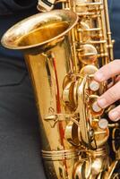 A saxophonist performs in a serene park during autumn while seated on a bench photo