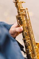 A saxophonist performs in a serene park during autumn while seated on a bench photo