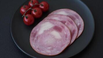 Ham cut into slices with salt and spices on a dark concrete background video