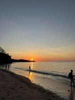a very beautiful sunset view on the shores of Teluk Gurita Beach photo