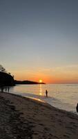 a very beautiful sunset view on the shores of Teluk Gurita Beach photo
