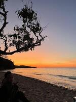 a very beautiful sunset view on the shores of Teluk Gurita Beach photo