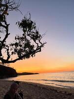 a very beautiful sunset view on the shores of Teluk Gurita Beach photo