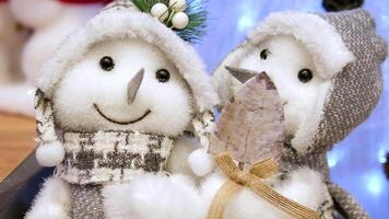 snowmen toy Adorable plush snowmen dressed in cozy winter hats and scarves, capturing the essence of festive cheer and holiday decorations. video
