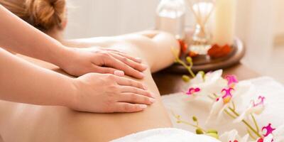 Hands of masseur on back of girl during massage photo