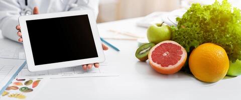Technologies in healthcare. Cropped of doctor showing afro woman patient blank digital tablet screen photo