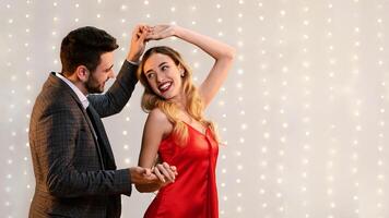 Cheerful Romantic Couple Dancing Together On Date In Restaurant, Holding Hands And Enjoying Valentine's Day Celebration, Empty Space photo