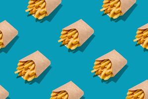 Lots Of French Fries In Paper Boxes Over Blue Background, Geometric Seamless Design, Creative Repeat Pattern, Top View photo