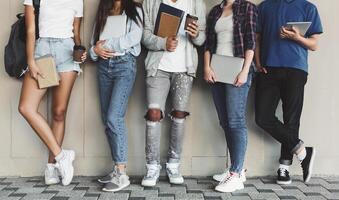 Modern students. Group of Diverse Teenagers Posing with Gadgets and Books, panorama with empty space photo