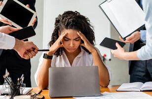 Multitasking. Overworked Business Lady Sitting Stressed By A Lot Of Tasks At Work In Modern Office. photo