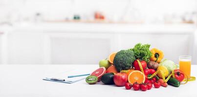 Nutritionist's empty workplace with fruits, vegetables, measuring tape and medical chart on table, panorama with copy space photo