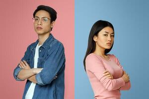 Break up. Upset asian man and woman standing back to back, gray studio background photo