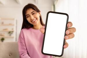Greeting Concept. Portrait of smiling beautiful woman waving hello with hand looking at camera, using laptop at home office. Cheerful lady saying hi or goodbye during call, blurred background photo